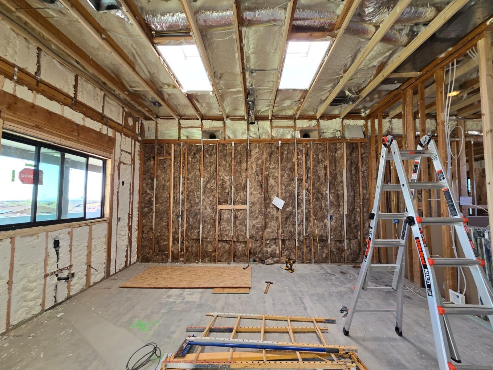Fiberglass batt insulation installed alongside spray foam
