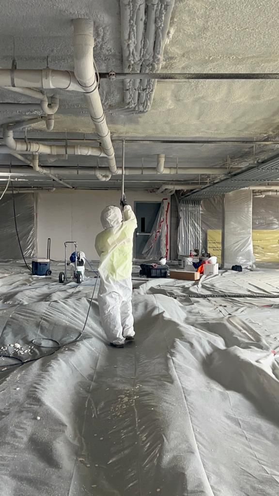 BW Insulation crew spraying foam insulation on a jobsite